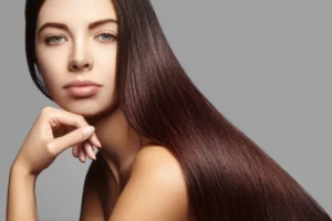 Woman showing off silky, shiny hair after keratin hair treatment.