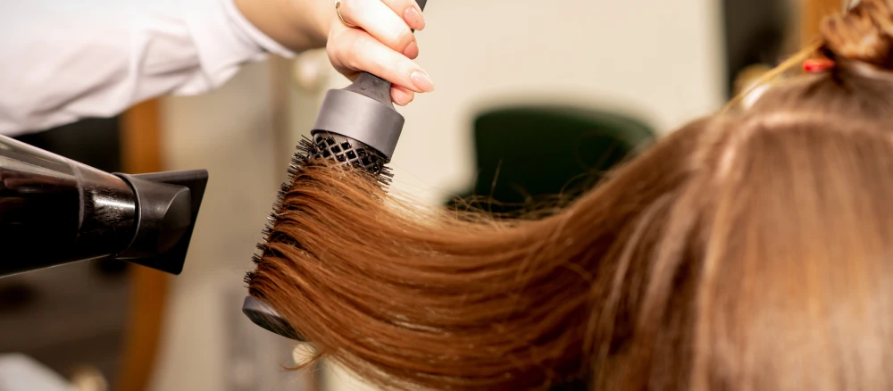 Woman's hair styled after receiving full highlights treatment.