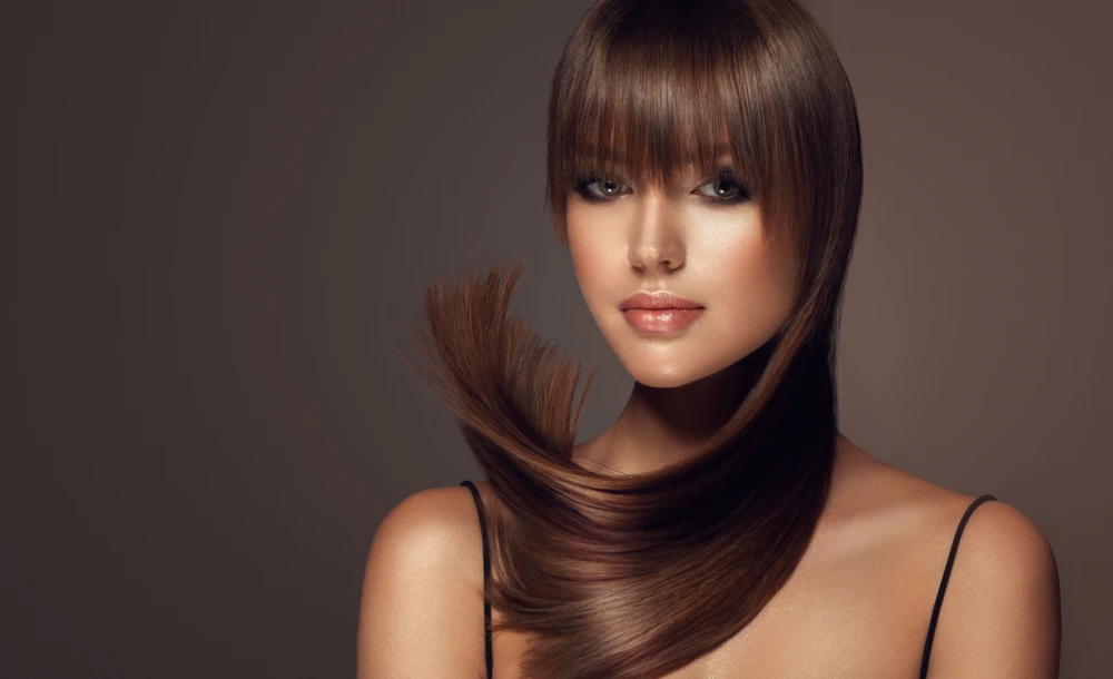 Model with sleek and shiny hair after keratin hair treatment.